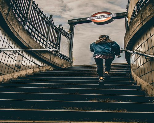 Person walking up stairs comfortably in an urban environment